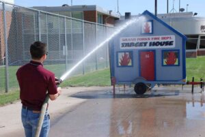 ARFF Open House Guest Jonathan Sepulveda with firehose demonstration